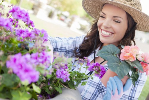 Gardener pruning shrubs in a Camden backyard