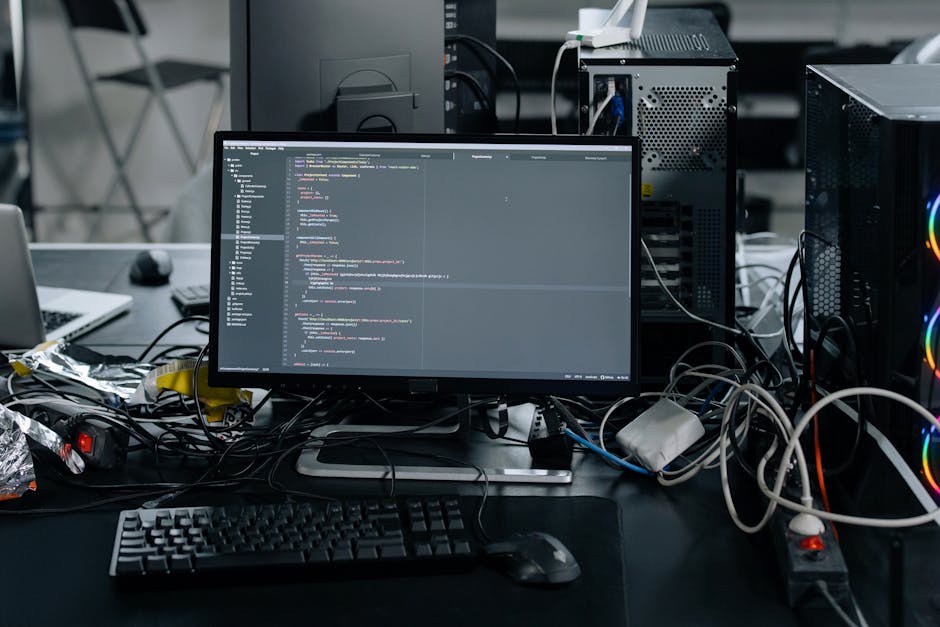 A close-up view of a laptop screen displaying lines of code in a dark-themed code editor, situated on a wooden desk. To the right of the laptop, there is a ceramic mug with a beige exterior featuring 